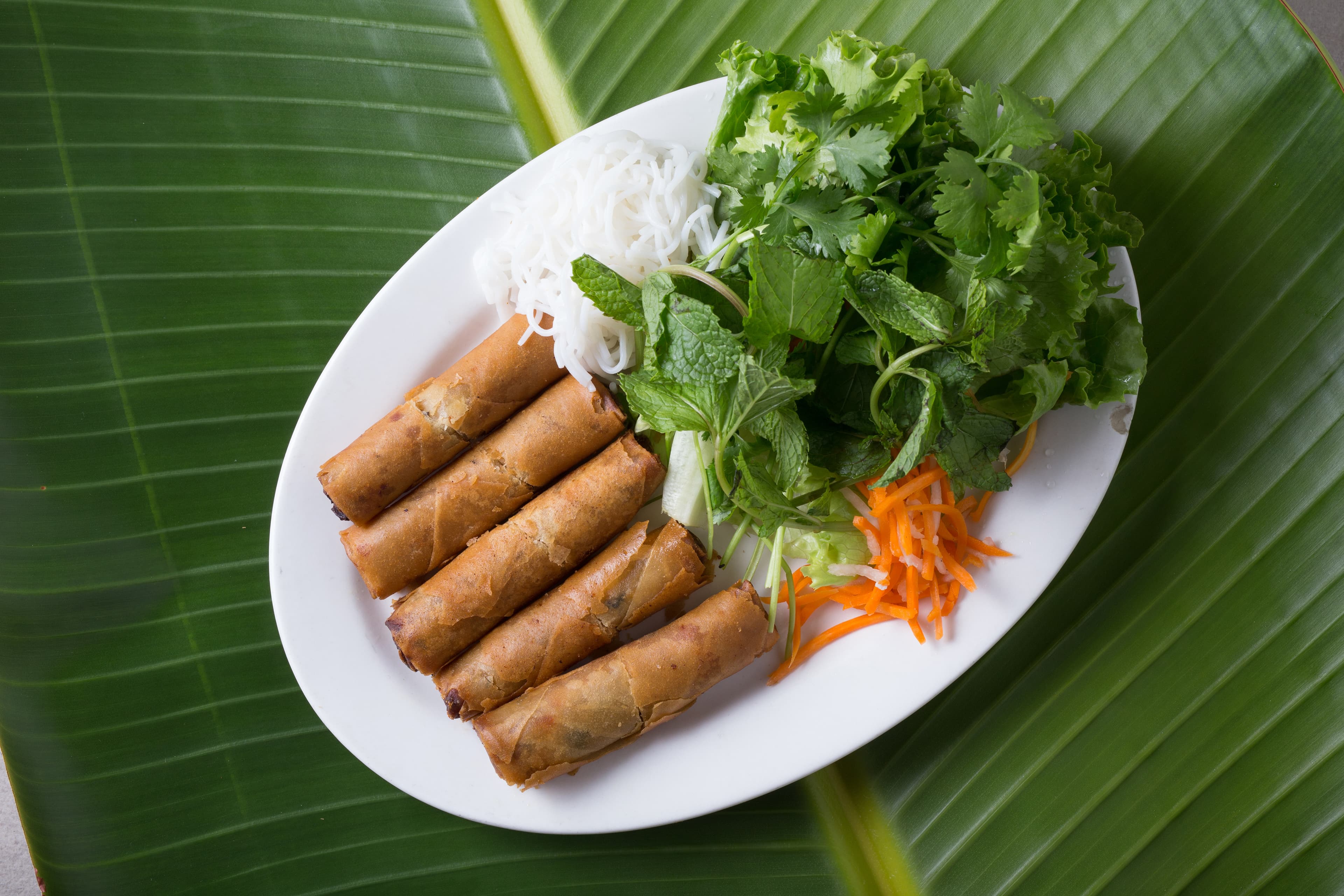 Chef preparing fresh pho ingredients in the Pho Tasty kitchen
