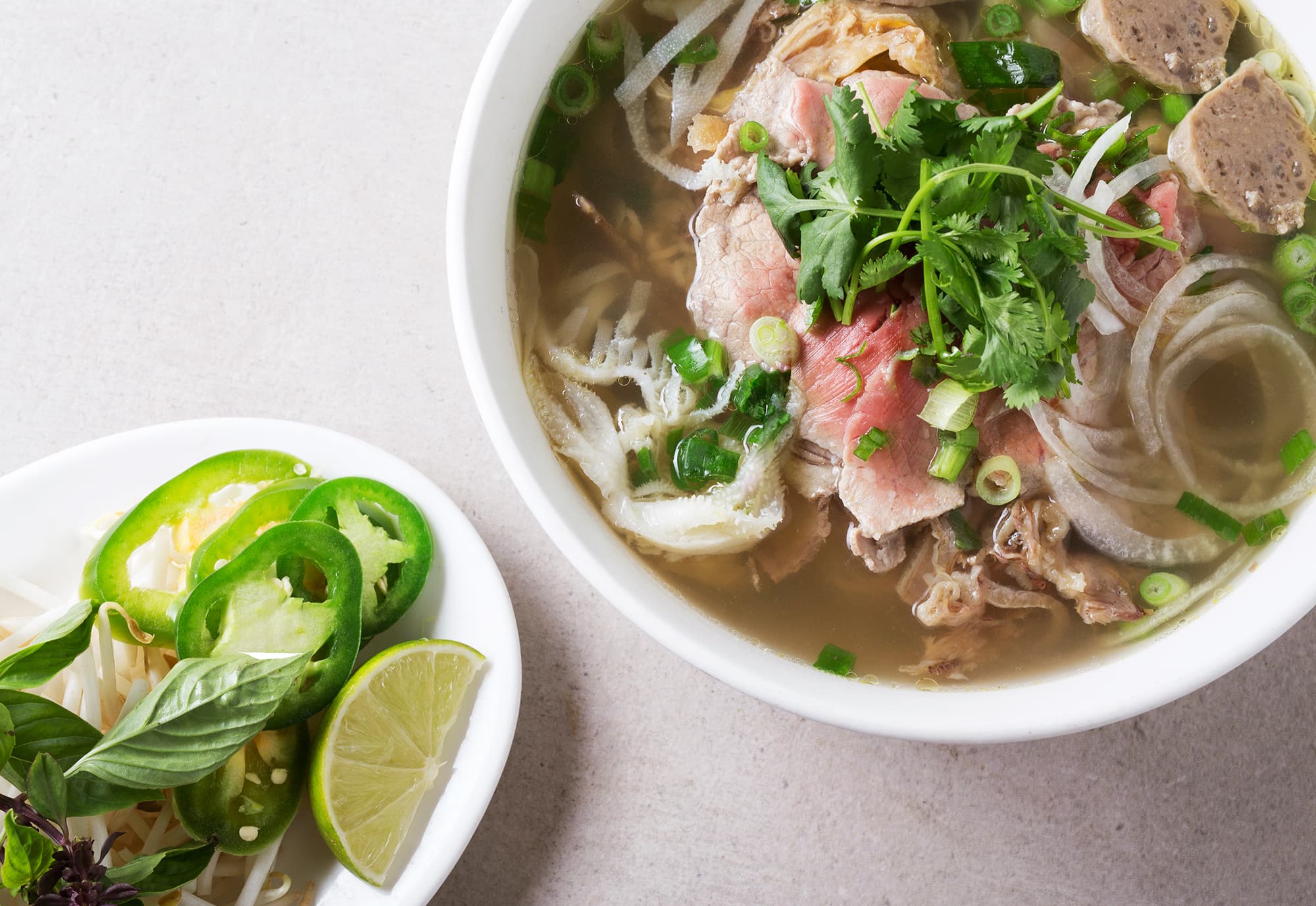 A bowl of Pho Tasty pho with fresh herbs, beef, and noodles